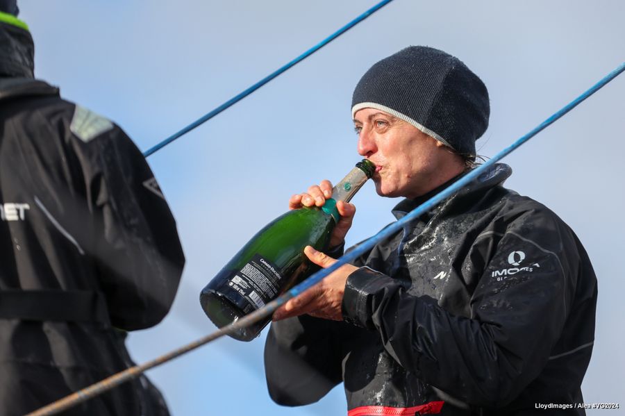 TeamWork - Team Snef skipper Justine Mettraux (SUI) is celebrating with champagne after taking 8th place in the Vendee Globe, on January 25, 2025 in Les Sables d'Olonne, France - Photo credit: LloydImages / Alea